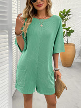 Model styled in green Breezy Bold Romper paired with strappy heels at a casual business meeting.