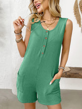 Seated in a rattan chair with iced matcha in hand, green Solstice Drift Romper drapes naturally and stylishly.
