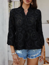 Model in Black Luméa™ Blouse, paired with a skirt and brown straw handbag for an evening event.