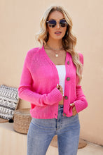 Front view of a woman wearing the Solavelle™ V-Neck Cardigan in hot pink, featuring a flattering V-neckline, button-up front, and long sleeves.