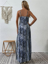 Back shot photo of a model posing in the dusty blue color Jewel of Northern Lights Maxi Cami Dress paired with jewelry.