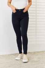 a woman modeling a front view of Navy Judy Blue Full Size Garment Dyed Tummy Control Skinny Jeans at a studio