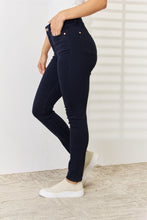 a woman modeling a side view of the Navy Judy Blue Full Size Garment Dyed Tummy Control Skinny Jeans at a studio