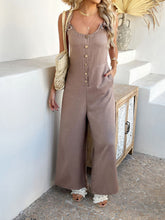 Taupe jumpsuit paired with a crossbody bag for effortless elegance.