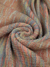 Close-up shot of khaki Heathered Fringe Hem Poncho, capturing the textured knit weave, multicolor thread accents, and whimsical pom pom fringe at the hem.