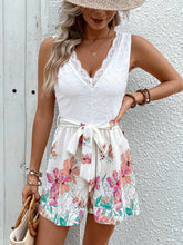 Close-up of romper’s white lace bodice and floral print fabric showcasing fine texture, breathable fabric, and intricate design for a refined, airy look.