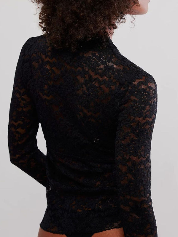 Model showcasing a Back view of the black Laceaura Top revealing lace pattern and subtle sheerness.