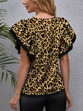 Back view of the olive leopard print blouse highlighting the flowy flounce sleeves and relaxed silhouette.