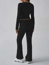 Back view of model wearing Black Liahnique square neck top and ruched waist bootcut pants