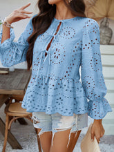 Model at a brunch gathering wearing PeplumMuse™ Blouse in Light Blue, paired with distressed jean shorts, tan ruffled handbag, gold hoop earrings, and white sandals.