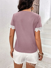 Back view of model dressed in a lilac Lace Detail V-Neck Short Sleeve T-Shirt, with lace-detailed short sleeves and smooth, lightweight fabric.