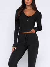 Close-up of buttons and tie waist on Lunavena black top