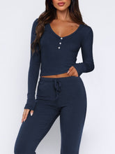 Close-up of buttons and tie waist on Lunavena navy top