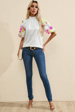 Model wearing LustruBloom Blouse paired with casual jeans, white handbag, heels, and accessories.