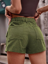 Rear view of the subtle matcha green high-waist denim shorts showcasing pocket details.