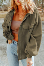Model dressed in matcha green Nivora™ DriftZip Hoodie with adjustable hood, zip closure, and chest pockets.
