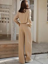 Model standing on a sidewalk with back turned wearing a Khaki Waffle-Knit Round Neck Top and Pants Set 