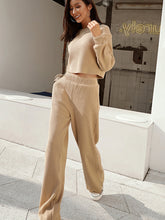 Model in Mellara Khaki Waffle-Knit Round Neck Top and Pants Set styled with sneaker and hoop earrings walking past the laundry mat 