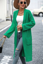 Model in mid green Thalora Cascade Cardigan with open front and pockets