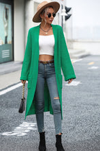 Woman wearing mid green cardigan on a park stroll, styled with leggings and tee for a relaxed weekend look
