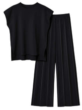 Front flat lay of Mirajella Luxe black cap sleeve top and pleated pants