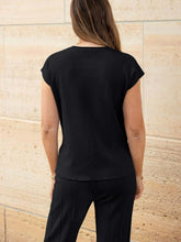 Close-up of knit texture and cap sleeve seams on Mirajella Luxe black top rear