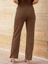 Close-up of wide leg pleated knit pants on model wearing Mirajella Luxe brown set