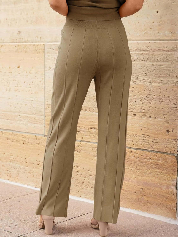 Close-up back view of wide leg pleated knit pants on model wearing Mirajella Luxe camel set