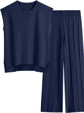 Front flat lay of Mirajella Luxe dark blue cap sleeve top and pleated pants
