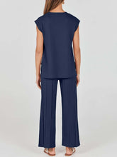 Model showcasing back view of Mirajella Luxe Dark Blue wide leg pleated knit pants set