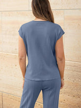 Close-up of knit texture and cap sleeve seams on Mirajella Luxe dusty blue top rear