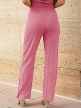Close-up of wide leg pleated knit pants and elastic waist on model wearing Mirajella Luxe dusty pink set