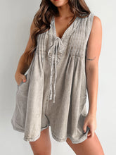 Model in mocha romper with soft curls and gold-toned jewelry—earth-toned luxe meets modern ease.