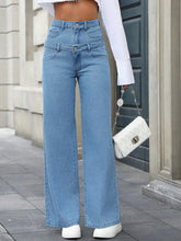 Model wearing Dualisse™ high waist jeans with faux layered waistband, front view.