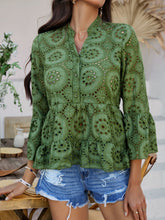 Model in Moss Luméa™ Blouse, paired with a skirt and brown straw handbag attending an art gallery event. 