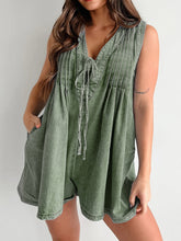 Hiking trail ready—model wearing moss romper with canvas backpack and sporty sneakers, glowing with nature energy.