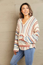 Close-up of the Ollavon™ Striped Hoodie fabric showing soft, breathable knit texture and vibrant multicolor stripes with neat stitching detail.