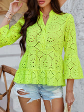 Close-up of Neon Yellow Luméa™ Blouse's eyelet fabric and half-button closure on model paired with a straw hat and accessories for a casual look.