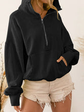 A model wearing the black color Nuvella Zip-Up Dropped Shoulder Hoodie paired with distressed tan denim shorts.