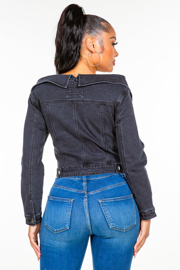 a model showcasing the black American Bazi Off Shoulder Lace Up Denim Jacket  from the back paired with jewelry and blue jeans