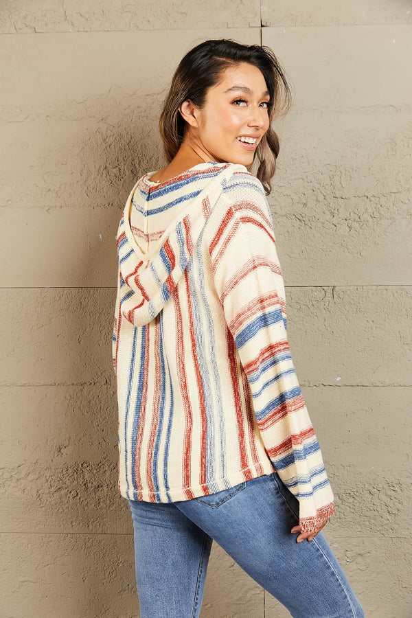 Back view of the Ollavon Striped Hoodie showing the relaxed fit, dropped shoulders, vibrant multicolor stripes, and the cozy hood draped naturally.