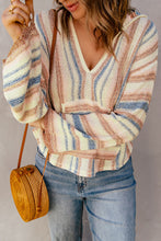 Front view of a woman wearing the Ollavon Striped Hoodie, showcasing bold multicolor stripes and a casual, relaxed fit.