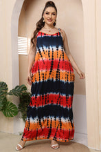 Woman posing in the multicolor Tie-Dye Ombravelle Maxi Dress paired with jewelry and white heels.