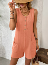 Sitting on patterned tiles with sandals and bangles, orange romper pops with playful charm.