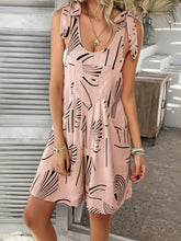 Model wearing Kélure pale blush printed tie shoulder overalls front view, showing feminine tones and breezy cut.