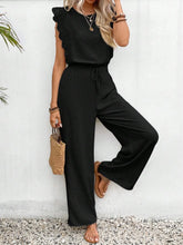 Model posing in black Papiloniya™ Lace Trim Top and Pants Set, styled with jewelry and loafers at a dinner reservation.