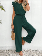 Model posing in dark green  Papiloniya™ Lace Trim Top and Pants Set, styled with jewelry and loafers at a dinner reservation.