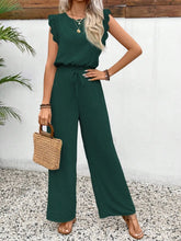 Lifestyle shot of the dark green Papiloniya™ Lace Trim Set worn for an outdoor brunch, paired with sandals, a tan straw handbag, and platinum silver jewelry.