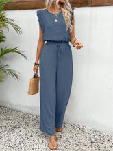 Model wearing the Papiloniya™ Lace Trim Round Neck Top and Pants Set in dusty blue. Featuring ruffled lace trim top and wide-leg pants, styled with sandals and accessories for a polished complete look.