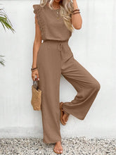Lifestyle shot of the Taupe Papiloniya™ Lace Trim Set worn for an outdoor brunch, paired with sandals, a tan straw handbag, and platinum silver jewelry.
